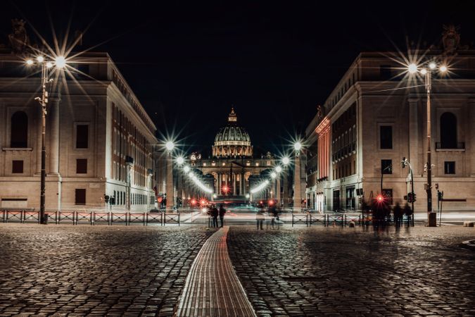 People walking on sidewalk near Adrian Park in Rome, Italy during night time