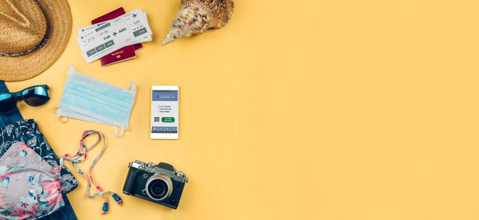 Set with mobile covid passport and beach holiday objects