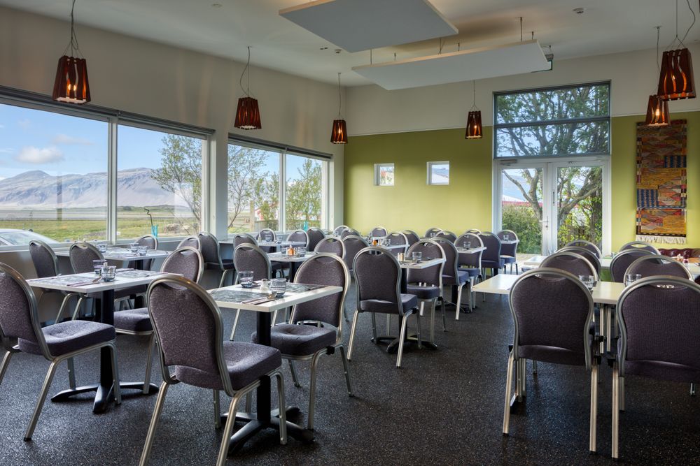 Dinning room with wonderful view of summer mountain landscape from window in hotel