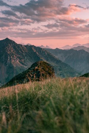 Stony valley surrounded by mountain under cloudy sky