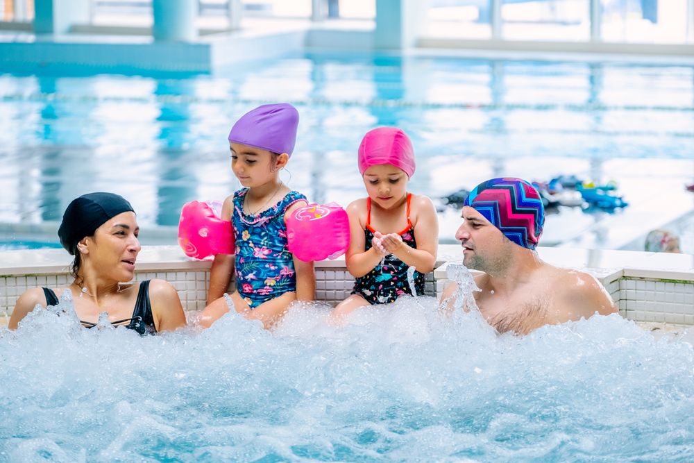 Family relaxing in bubbling pool
