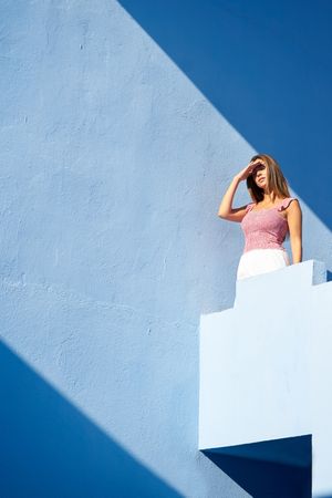 Woman standing on the top of a blue building