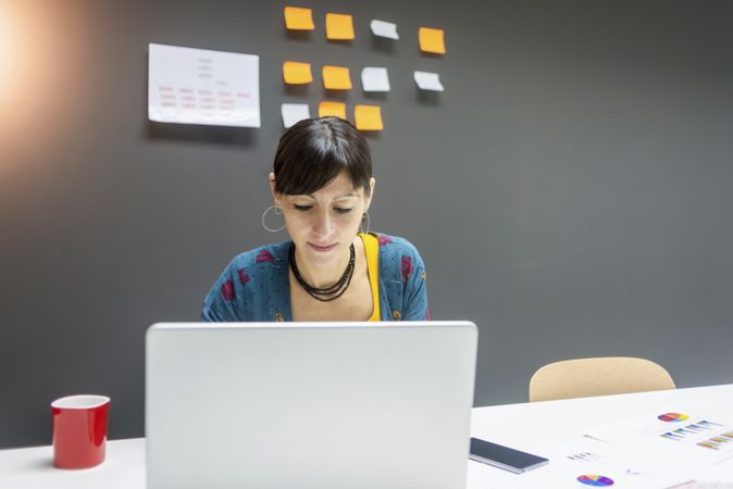 Smiling businesswoman working with laptop