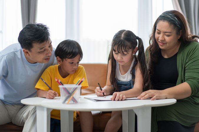 Asian family doing children’s home together together