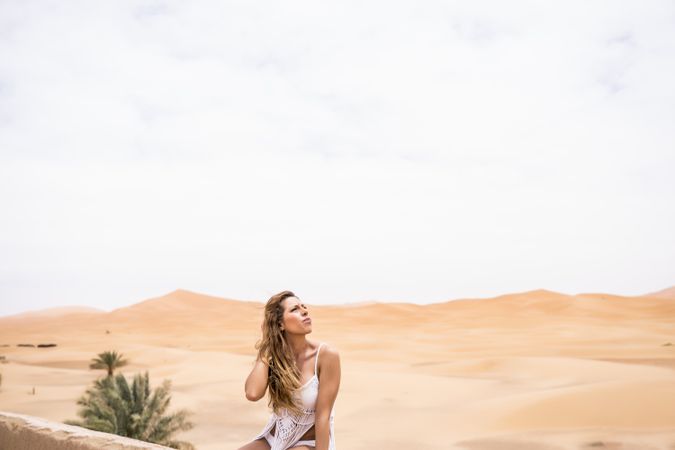 Woman on terrace against desert landscape