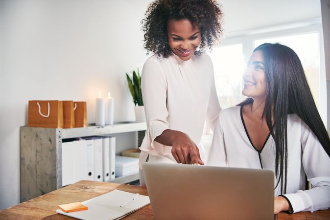 Two female designers working in a bright office