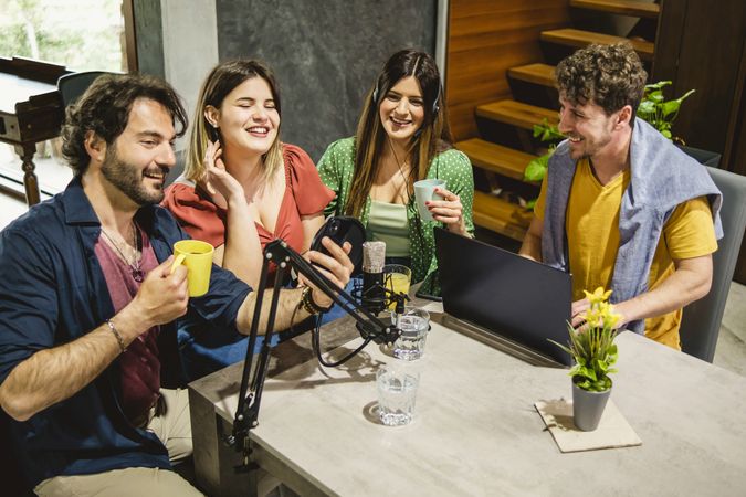 Young adults recording a podcast in studio