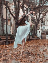 Graceful woman dancing ballet on street