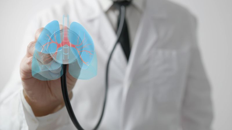 Doctor uses stethoscope with lung hologram