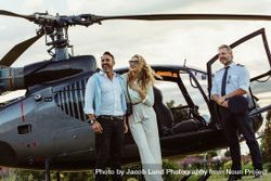 Couple standing by a helicopter with pilot 5Q2gA9