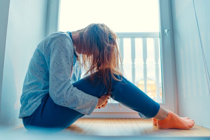 Woman at home clothes on window sill
