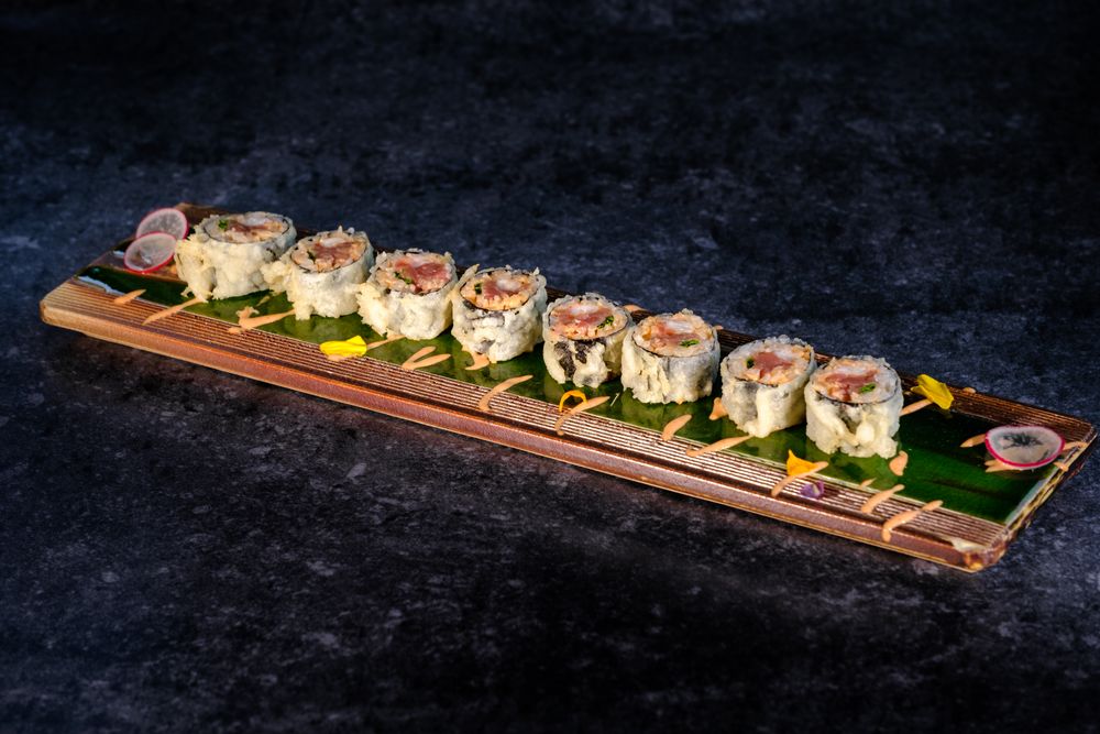 Delicious fried sushi with cream on tray