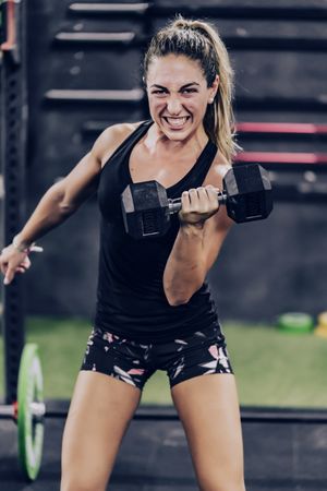 Muscular woman training with weight