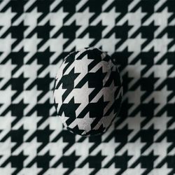 Easter egg decorated with paper napkins in matching houndstooth pattern