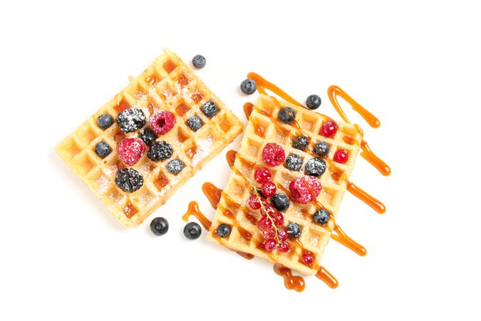 Waffles under caramel topping isolated on blank background