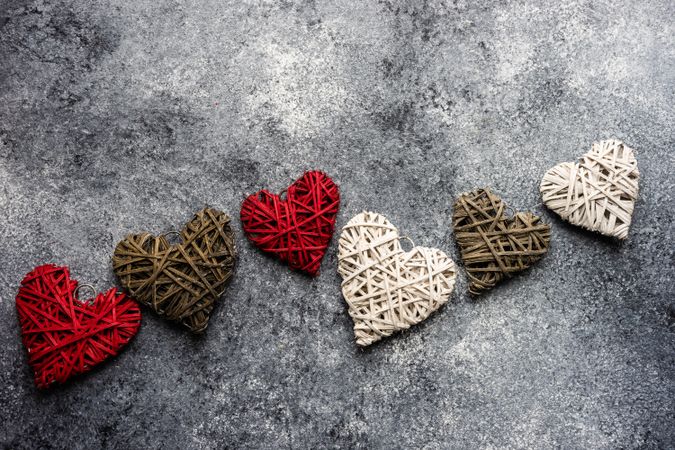 Thatched heart ornaments scattered on grey counter