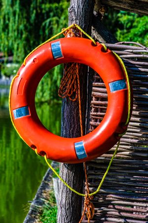 Close up of red bouy by lake