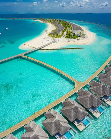 Aerial shot of holiday villas at a beach resort in the Maldives