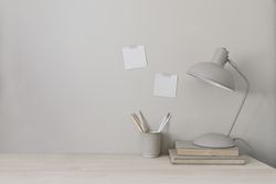 Wooden desk with lamp, books and cup holder for pencils