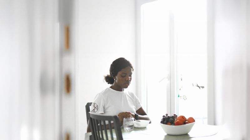 Casual Morning Scene: Woman Eating Cereal at Home.