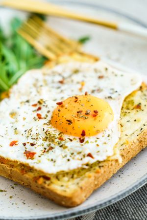 Delicious breakfast of fried eggs with toast and salad.