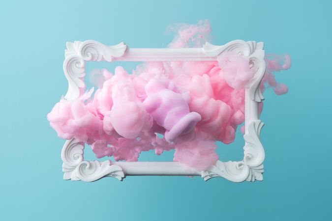 Cloud-like pink color paint with picture frame on blue background