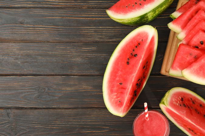Composition with watermelon slices and juice on wooden background. Summer fruit
