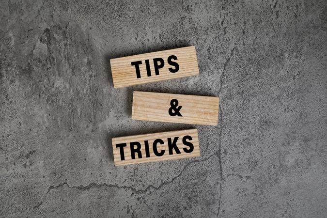 tips and tricks words on wooden blocks isolated on cement background