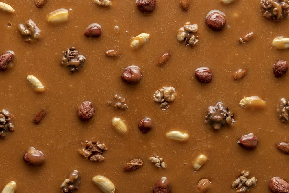 Caramel sauce and nuts background