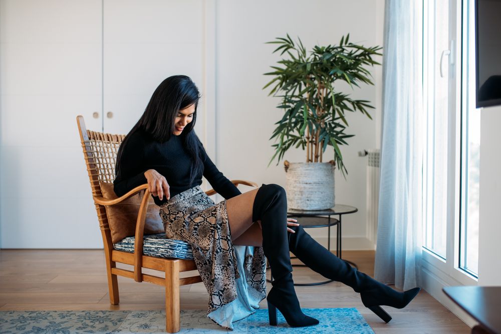 Stylist beautiful young Black woman sitting in a chair