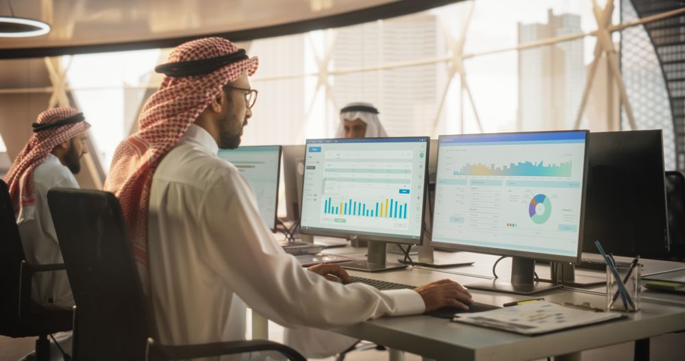 Arab Market Financial Analyst Working in a Research and Development Facility on a Desktop Computer.