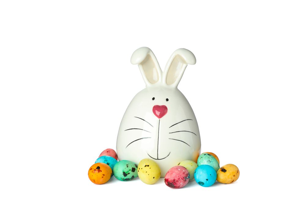 Decorated bunny and Easter eggs isolated on plain background. Festive tradition