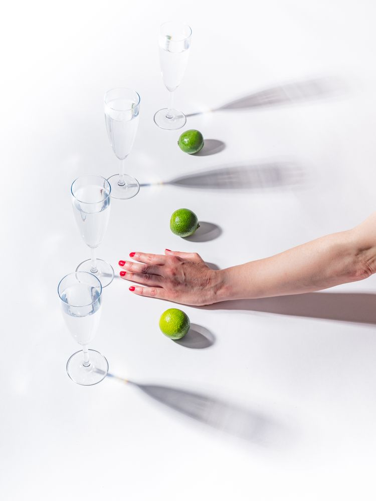 Composition of a hand with citrus and glasses of water