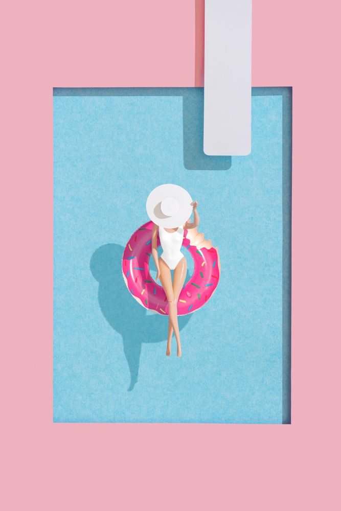 Barbie-like doll in donut ring in pool