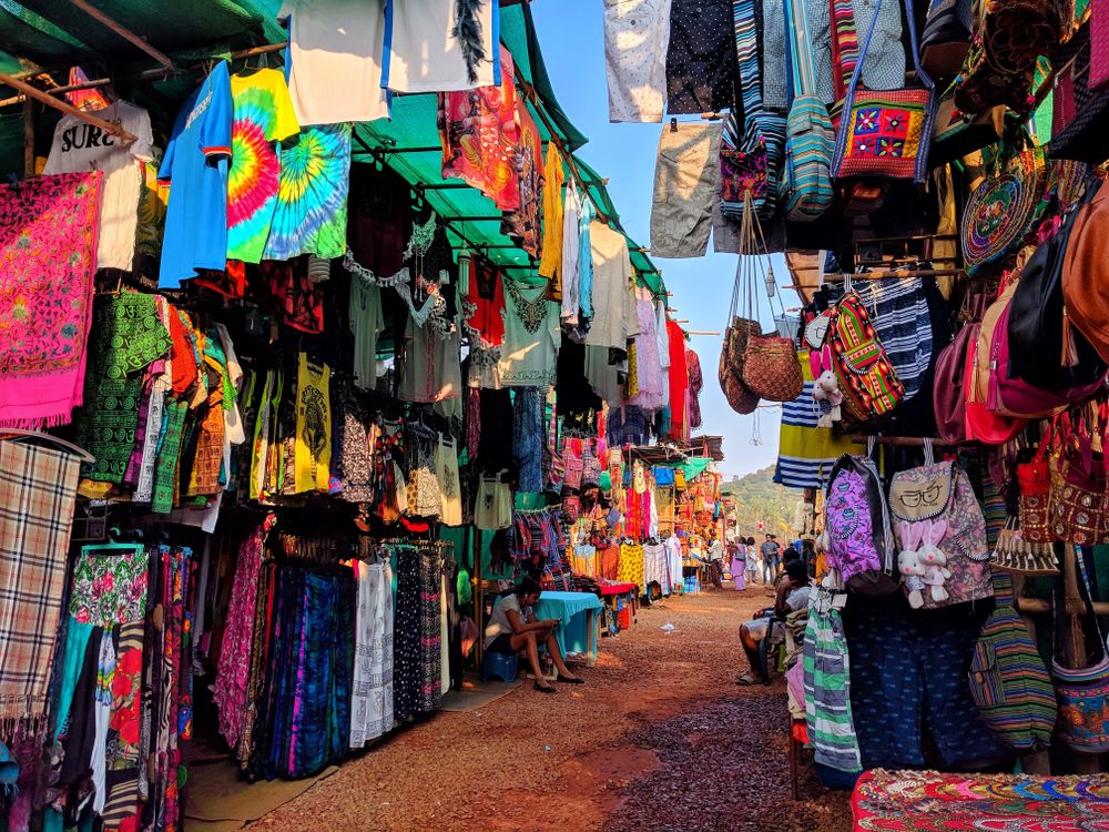 Assorted clothes and bags at the market store in Arpora, Goa, India
