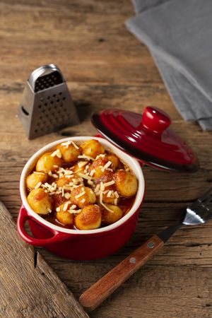 Gnocchi with tomato sauce and grated Parmesan cheese.