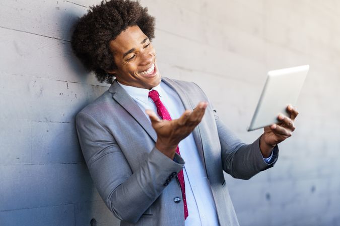 Man chatting on a tablet outside of office