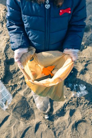 Girl showing garbage collected from the beach