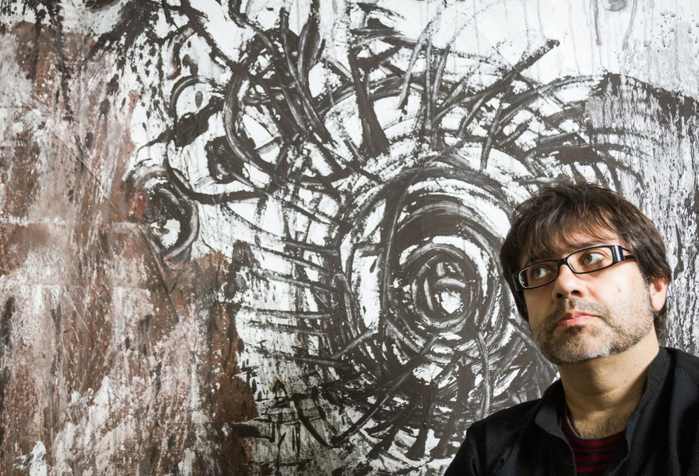 Painter artist posing in front of paint
