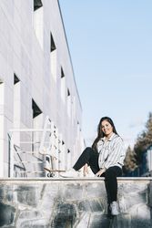 Young woman posing with skateboard