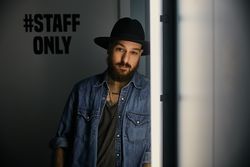 man in hat looking at camera in room