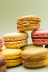 Pile of fine French macaroon on a green table