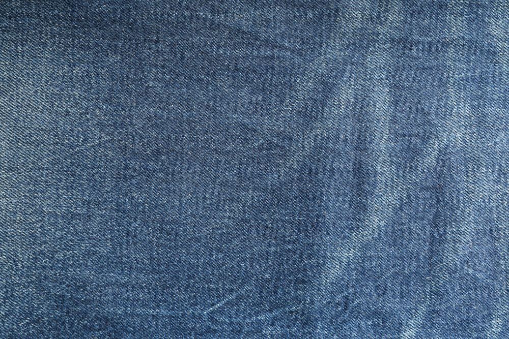 Texture of blue jeans as background, space for text