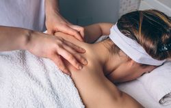 Client receiving shoulder massage in spa