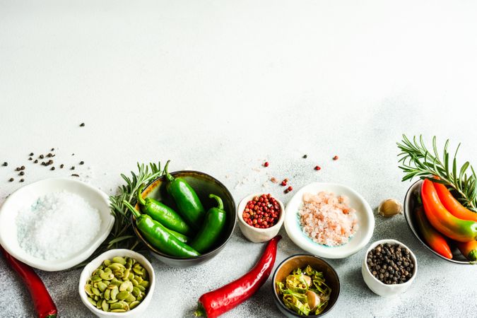 Vegetables, seasoning and rosemary on counter with copy space