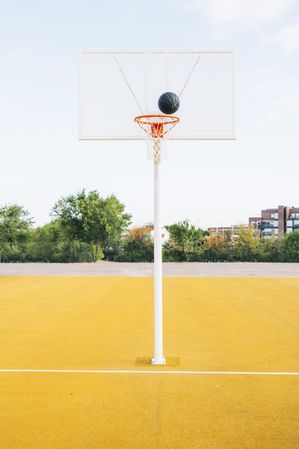 Outdoor yellow basketball court and ball