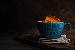 Dried persimmon fruit slices in tea cup