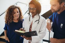 Group of doctors and nurses going over notes together
