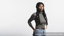 Portrait of Black woman in jeans and tshirt and long dreadlocks with cowrie shells 4829K0