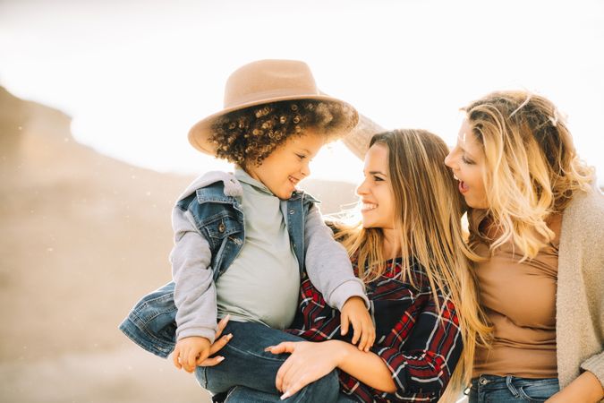 Smiling blond women walking with curly child